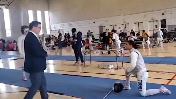 Stephanie Turner takes s knee in a fencing match against a man pretending to be a woman (Video screenshot)